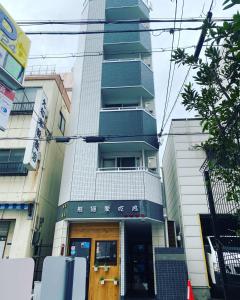 a tall building with a door in front of it at shizuka1 501 in Osaka