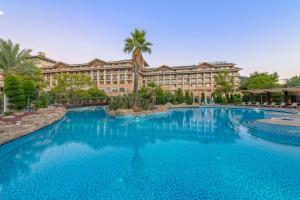 a large pool in front of a hotel at Amara Luxury Resort & Villas in Kemer