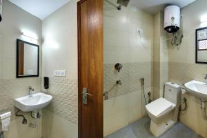 a bathroom with a sink and a toilet and a shower at Hotel TMS Grand in New Delhi