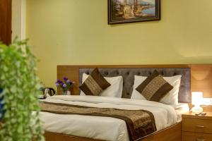 Postel nebo postele na pokoji v ubytování Hotel TMS Grand