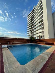 a large swimming pool in front of a building at Bitcoins House Costanera in Corrientes