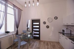 a kitchen with a table and a dining room at Wellnes apartmán Leqwell in Uherský Brod