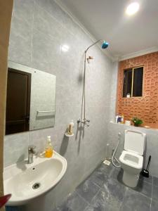 a bathroom with a sink and a toilet at Lovely and homely 2 bedroom Serviced Apartment in Kilifi