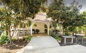 a white house with trees and a patio at Hollyday & vacation in Beit Hillel