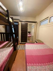 a bedroom with two bunk beds and a chandelier at 2 Bedroom Ground floor Chalet with Terrace - Porto Sokhna - Families Only in Ain Sokhna