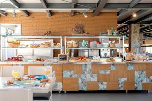 a restaurant with a counter with plates of food at Skiros Palace Hotel in Skiros
