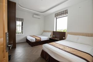 Postel nebo postele na pokoji v ubytování Nhà Nghỉ Ngọc Anh