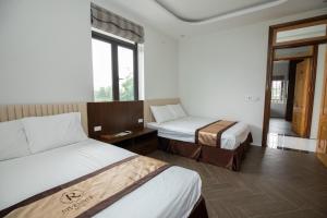 Postel nebo postele na pokoji v ubytování Nhà Nghỉ Ngọc Anh