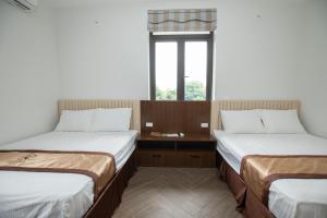 Postel nebo postele na pokoji v ubytování Nhà Nghỉ Ngọc Anh