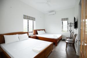 Postel nebo postele na pokoji v ubytování Nhà Nghỉ Ngọc Anh