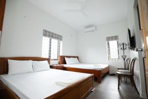 Postel nebo postele na pokoji v ubytování Nhà Nghỉ Ngọc Anh