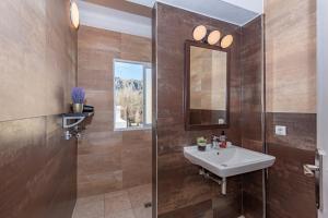 a bathroom with a sink and a mirror at On The Beach Voramar by Sealand Villas in Port de Pollensa +19 photos