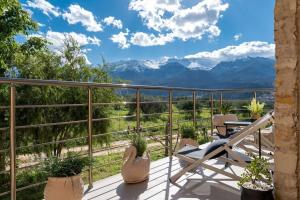 a balcony with chairs and a view of mountains at Stone villa Halepa with panoramic view. in Néon Khoríon