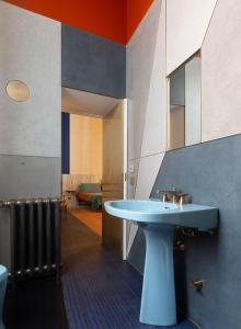 a bathroom with a blue sink and a mirror at Palazzo Luce in Lecce