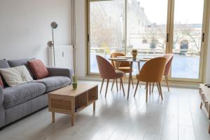 - un salon avec un canapé, une table et des chaises dans l'établissement Superbe appartement avenue de Champagne + parking, à Épernay