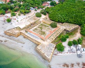 uma vista aérea das ruínas de um edifício na praia em Villa Velha Flats em Itamaracá