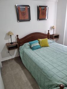 1 dormitorio con 1 cama verde y 2 mesitas de noche en UMA en Salta