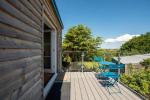 una terraza con 2 sillas y una mesa en una casa en Converted Hay-loft with Stunning Countryside Views en Haverfordwest