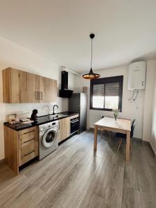 a kitchen with a table and a stove top oven at Apartamentos CEO - Naranja in Ronda