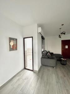 a living room with a couch and a window at Apartamentos CEO - Naranja in Ronda