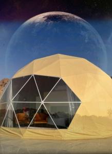 a rendering of a white dome with a moon in the background at Amanda Luxury Camp in Wadi Rum