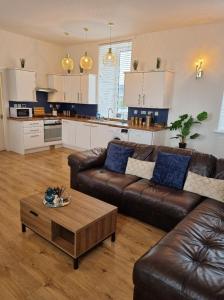 a living room with a couch and a coffee table at City Centre Flat, Harbour View in Inverness