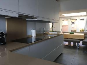 a kitchen with a sink and a counter top at Luxurious & modern on-the-beach family retreat in Boulmer