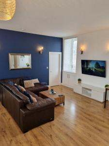a living room with a couch and a table at City Centre Flat, Harbour View in Inverness