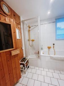 a bathroom with a shower and a tub and a sink at Ferienwohnung zum Schreckenberg in Annaberg-Buchholz