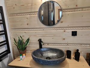 a bathroom sink on a counter with a mirror at beskid house in Spytkowice +15 photos