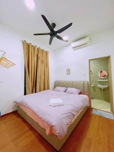a bedroom with a bed with a ceiling fan at My Homestay @ Morib Bay Banting in Banting +49 photos