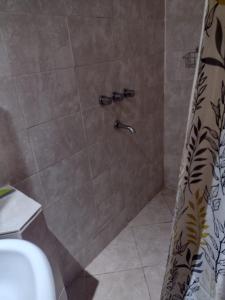 a shower in a bathroom with a shower at Depto. El duende in Olavarría
