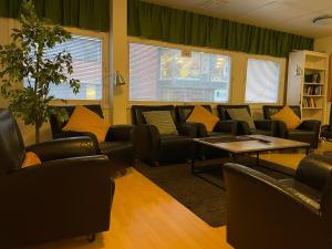 a waiting room with couches and a table at Uppsala City Hostel in Uppsala