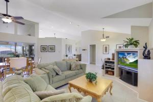 a living room with a couch and a tv at 1221 Lamplighter Court in Marco Island
