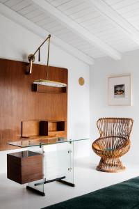 a glass table and a chair in a room at Palazzo Luce in Lecce