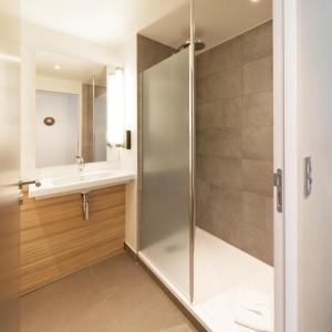 a bathroom with a shower and a sink at Campanile Rungis - Orly in Chevilly-Larue