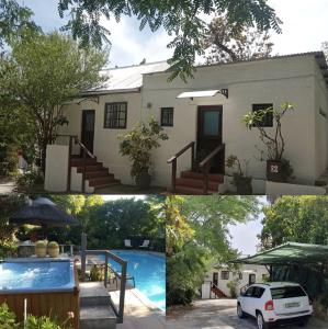 una casa con piscina frente a ella en Santika Getaway Cottage Stellenbosch, en Stellenbosch