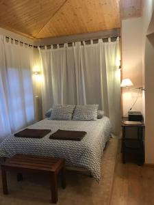 a bedroom with a large bed with a wooden ceiling at Casa Mirador de Entrepeñas in Guadalajara +40 photos