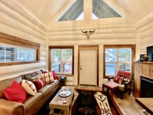 a living room with a couch and a table at Black Bear Cabin 2 in Whitefish