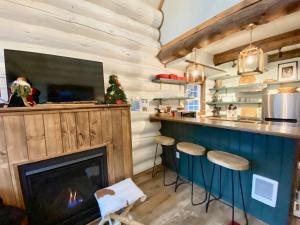 a living room with a fireplace and a tv at Black Bear Cabin 2 in Whitefish