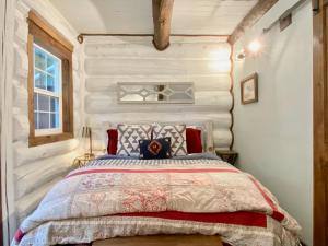 a bedroom with a bed and a wooden wall at Black Bear Cabin 2 in Whitefish