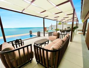 a patio with chairs and a view of the ocean at Dana Beach Resort in Half Moon Bay