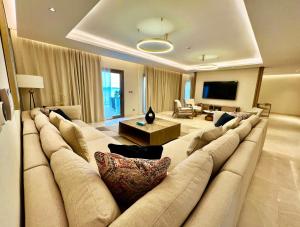 a living room with a large couch and a television at Dana Beach Resort in Half Moon Bay