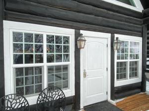 a white door and windows on a house at Black Bear Cabin 3 in Whitefish