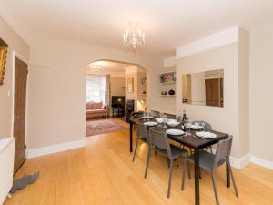 a dining room with a black table and chairs at Pass the Keys 3 Storey Townhouse in Shrewsbury