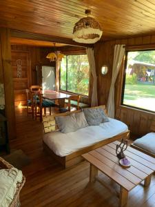 a living room with a couch and a table at Cabaña Pucón in Pucón