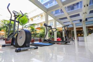 a group of treadmills and exercise bikes in a gym at Sylvia Hotel Kupang in Kupang