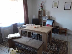 uma sala de estar com uma mesa de madeira e uma cadeira em Ferienwohnung am Ginkgo Baum em Bad Pyrmont