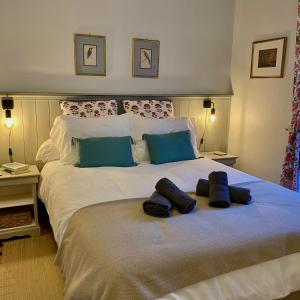 a large white bed with two pillows on it at Newly Renovated Ground Floor Apartment close to Thermes in Luchon