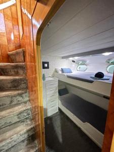 a small room with a bed and a staircase at Yate Aloha in Barcelona